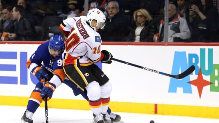 Nov 28, 2016; Brooklyn, NY, USA; Calgary Flames right wing Kris Versteeg (10) and New York Islanders center John Tavares (91) fight for the puck during the overtime period at Barclays Center. Mandatory Credit: Brad Penner-USA TODAY Sports