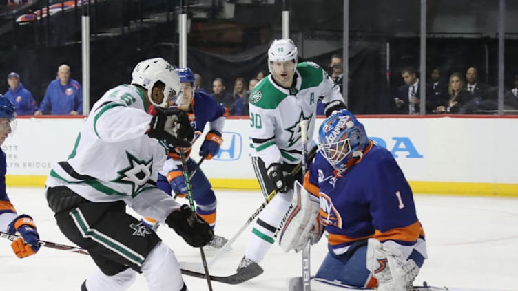 NEW YORK, NEW YORK - NOVEMBER 18: Thomas Greiss #1 of the New York Islanders Jason Dickinson #16 of the Dallas Stars at the Barclays Center on November 18, 2018 in the Brooklyn borough of New York City. (Photo by Bruce Bennett/Getty Images)