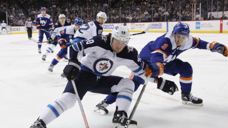 NEW YORK, NEW YORK - DECEMBER 04: Brendan Lemieux #48 of the Winnipeg Jets attempts to get around Adam Pelech #3 of the New York Islanders during the first period at the Barclays Center on December 04, 2018 in the Brooklyn borough of New York City. (Photo by Bruce Bennett/Getty Images)