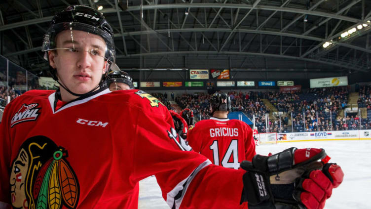 KELOWNA, BC - MARCH 02: Reece Newkirk #12 sits on the boards after fist bumping Jake Gricius #14 of the Portland Winterhawks to celebrate a goal against the Kelowna Rockets at Prospera Place on March 2, 2019 in Kelowna, Canada. (Photo by Marissa Baecker/Getty Images)