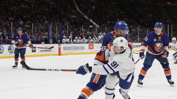 UNIONDALE, NEW YORK - APRIL 01: Johnny Boychuk #55 of the New York Islanders checks John Tavares #91 of the Toronto Maple Leafs during the first period at NYCB Live's Nassau Coliseum on April 01, 2019 in Uniondale, New York. (Photo by Bruce Bennett/Getty Images)