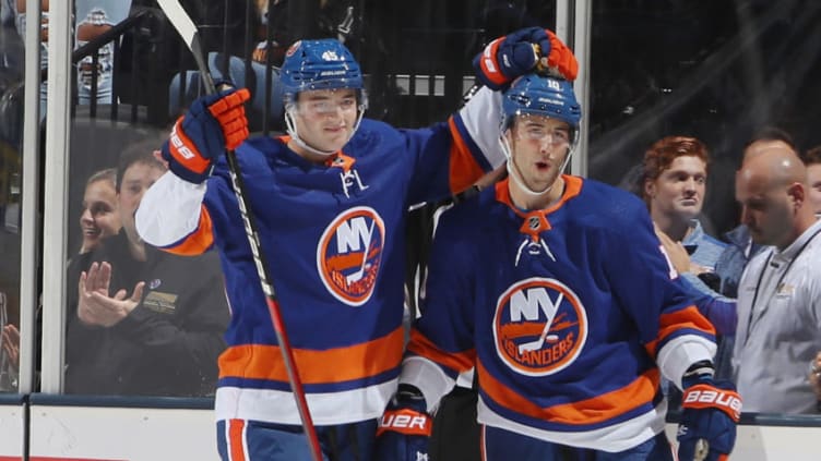 UNIONDALE, NEW YORK - SEPTEMBER 17: (L-R) Noah Dobson #45 and Derick Brassard #10 of the New York Islanders celebrate Brassard's third period goal against the Philadelphia Flyers at the Nassau Veterans Memorial Coliseum on September 17, 2019 in Uniondale, New York. The Islanders defeated the Flyers 3-2 in overtime. (Photo by Bruce Bennett/Getty Images)