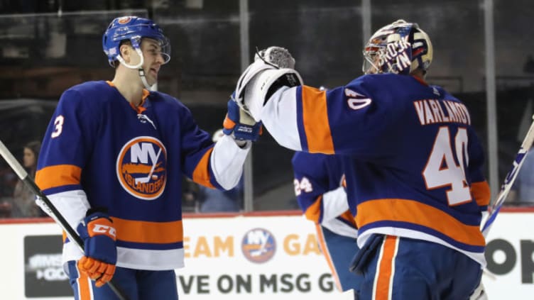 NEW YORK, NEW YORK - NOVEMBER 30: Adam Pelech #3 and Semyon Varlamov #40 of the New York Islanders celebrate a 2-0 shut-out against the Columbus Blue Jackets at the Barclays Center on November 30, 2019 in the Brooklyn borough of New York City. (Photo by Bruce Bennett/Getty Images)