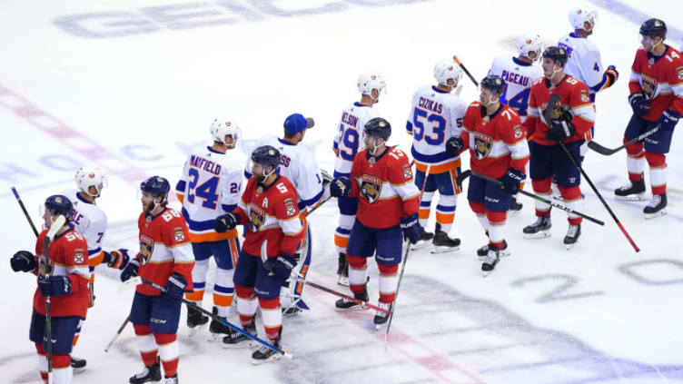 The Florida Panthers and the New York Islanders bump fists (Photo by Andre Ringuette/Freestyle Photo/Getty Images)