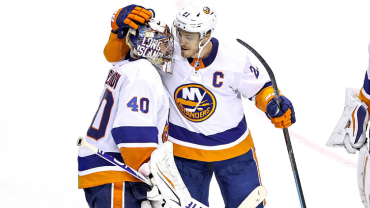 TORONTO, ONTARIO - AUGUST 24: Semyon Varlamov #40 of the New York Islanders is congratulated by his teammate Anders Lee #27 after his 4-0 shutout win against the Philadelphia Flyers in Game One of the Eastern Conference Second Round during the 2020 NHL Stanley Cup Playoffs at Scotiabank Arena on August 24, 2020 in Toronto, Ontario. (Photo by Elsa/Getty Images)