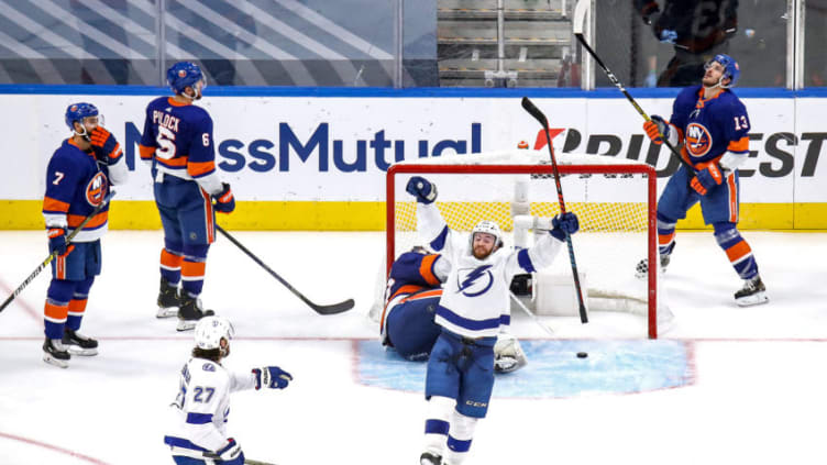 Brayden Point #21 of the Tampa Bay Lightning is congratulated by Ryan McDonagh #27 after scoring a goal past Semyon Varlamov #40 of the New York Islanders (Photo by Bruce Bennett/Getty Images)