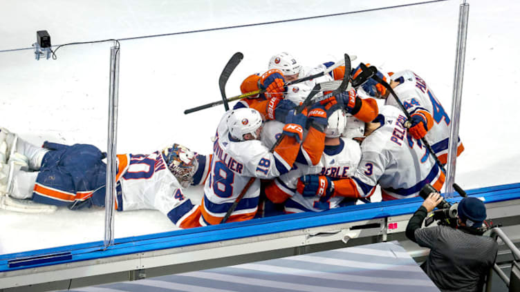 EDMONTON, ALBERTA - SEPTEMBER 15: Jordan Eberle #7 of the New York Islanders is congratulated by his teammates as Semyon Varlamov #40 dives toward the team after scoring the game-winning goal against the Tampa Bay Lightning during the second overtime period to win Game Five of the Eastern Conference Final during the 2020 NHL Stanley Cup Playoffs at Rogers Place on September 15, 2020 in Edmonton, Alberta, Canada. (Photo by Bruce Bennett/Getty Images)