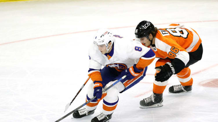 PHILADELPHIA, PENNSYLVANIA - JANUARY 30: Noah Dobson #8 of the New York Islanders tries to keep the puck from Joel Farabee #86 of the Philadelphia Flyers in the first period at Wells Fargo Center on January 30, 2021 in Philadelphia, Pennsylvania. (Photo by Tim Nwachukwu/Getty Images)