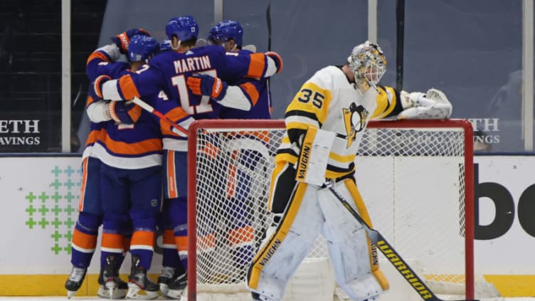 UNIONDALE, NEW YORK - FEBRUARY 06: The New York Islanders celebrate a goal by Cal Clutterbuck #15 against Tristan Jarry #35 of the Pittsburgh Penguins at 8:23 of the third period at the Nassau Coliseum on February 06, 2021 in Uniondale, New York. The Islanders defeated the Penguins 4-3. (Photo by Bruce Bennett/Getty Images)