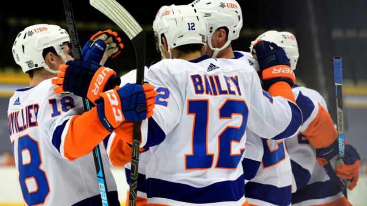 PITTSBURGH, PENNSYLVANIA - FEBRUARY 20: Scott Mayfield #24, Brock Nelson #29, Anthony Beauvillier #18, Josh Bailey #12 and Nick Leddy #2 of the New York Islanders celebrate a goal against the Pittsburgh Penguins at PPG PAINTS Arena on February 20, 2021 in Pittsburgh, Pennsylvania. (Photo by Emilee Chinn/Getty Images)