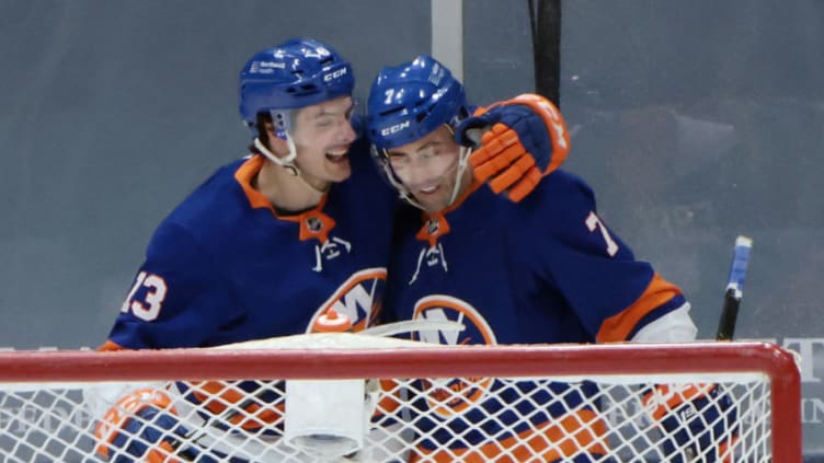 UNIONDALE, NEW YORK - FEBRUARY 25: Mathew Barzal #13 of the New York Islanders celebrates his first period goal against the Boston Bruins along with Jordan Eberle #7 at Nassau Coliseum on February 25, 2021 in Uniondale, New York. (Photo by Bruce Bennett/Getty Images)