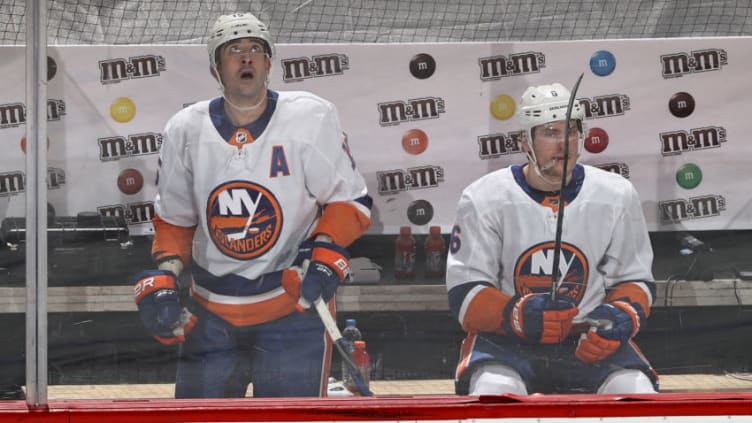 NEWARK, NEW JERSEY - MARCH 02: Cal Clutterbuck #15 and Ryan Pulock #6 of the New York Islanders are in the penalty box at the same time in the second period against the New Jersey Devils at Prudential Center on March 02, 2021 in Newark, New Jersey.Due to COVID-19 restrictions a limited number of fans are allowed to attend. (Photo by Elsa/Getty Images)