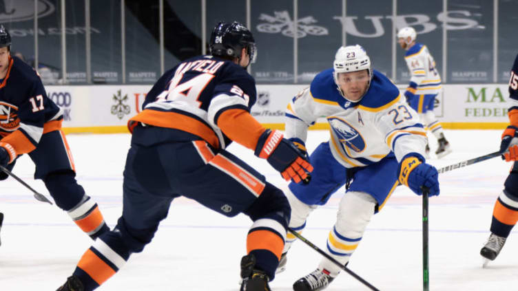 UNIONDALE, NEW YORK - MARCH 06: Sam Reinhart #23 of the Buffalo Sabres attempts to get around Scott Mayfield #24 of the New York Islanders during the first period at the Nassau Coliseum on March 06, 2021 in Uniondale, New York. (Photo by Bruce Bennett/Getty Images)