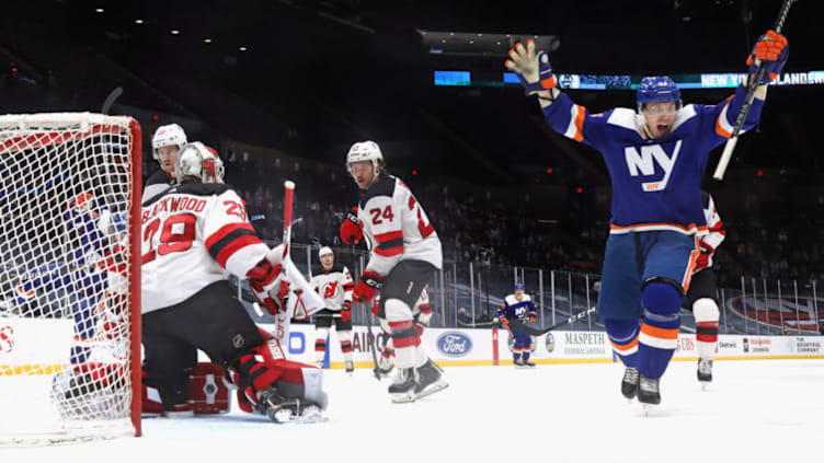 UNIONDALE, NEW YORK - MARCH 11: Casey Cizikas #53 of the New York Islanders celebrates a first period goal by Matt Martin #17 against Mackenzie Blackwood #29 of the New Jersey Devils at the Nassau Coliseum on March 11, 2021 in Uniondale, New York. The Islanders defeated the Devils 5-3. (Photo by Bruce Bennett/Getty Images)