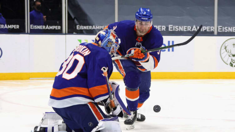 UNIONDALE, NEW YORK - APRIL 11: Ilya Sorokin #30 and Adam Pelech #3 of the New York Islanders skate against the New York Rangers at the Nassau Coliseum on April 11, 2021 in Uniondale, New York. The Islanders defeated the Rangers 3-2 in overtime. (Photo by Bruce Bennett/Getty Images)