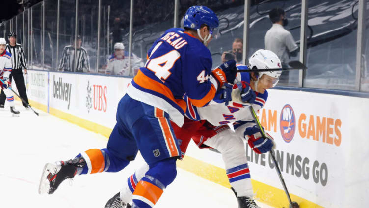 UNIONDALE, NEW YORK - MAY 01: Skaing in his first NHL game Morgan Barron #47 of the New York Rangers is checked into the boards by Jean-Gabriel Pageau #44 of the New York Islanders during the third period at the Nassau Coliseum on May 01, 2021 in Uniondale, New York. (Photo by Bruce Bennett/Getty Images)