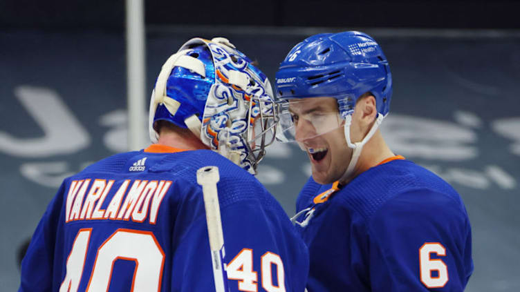 UNIONDALE, NEW YORK - MAY 01: Semyon Varlamov #40 and Ryan Pulock #6 of the New York Islanders celebrate their 3-0 shutout against the New York Rangers at the Nassau Coliseum on May 01, 2021 in Uniondale, New York. With the victory, the Islanders clinched a playoff berth to the 2021 Stanley Cup Playoffs. (Photo by Bruce Bennett/Getty Images)