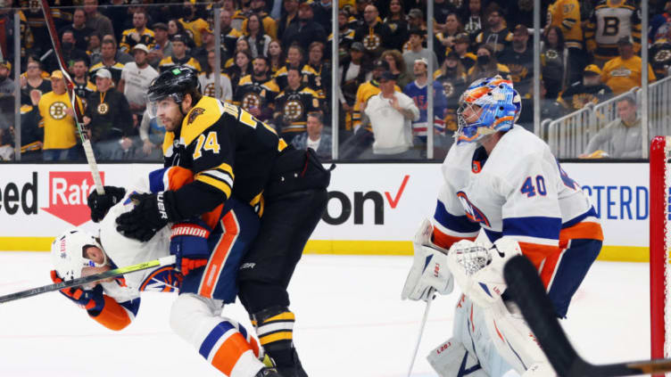 BOSTON, MASSACHUSETTS - MAY 31: Scott Mayfield #24 of the New York Islanders and Jake DeBrusk #74 of the Boston Bruins battle during the third period in Game Two of the Second Round of the 2021 Stanley Cup Playoffs at the TD Garden on May 31, 2021 in Boston, Massachusetts. (Photo by Bruce Bennett/Getty Images)