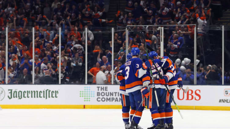 UNIONDALE, NEW YORK - JUNE 09: The New York Islanders celebrate an empty net goal by Cal Clutterbuck #15 of the New York Islanders against the Boston Bruins in Game Six of the Second Round of the 2021 NHL Stanley Cup Playoffs at the Nassau Coliseum on June 09, 2021 in Uniondale, New York. The Islanders defeated the Bruins 6-2 to move on to the Stanley Cup Semifinals against the Tampa Bay Lightning. (Photo by Bruce Bennett/Getty Images)