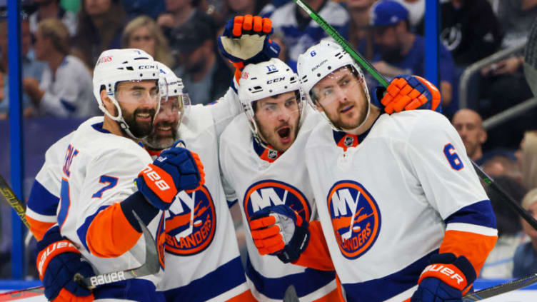 TAMPA, FLORIDA - JUNE 13: Ryan Pulock #6 of the New York Islanders is congratulated by Jordan Eberle #7, Andy Greene #4 and Mathew Barzal #13 after scoring a goal against the Tampa Bay Lightning during the third period in Game One of the Stanley Cup Semifinals during the 2021 Stanley Cup Playoffs at Amalie Arena on June 13, 2021 in Tampa, Florida. (Photo by Bruce Bennett/Getty Images)
