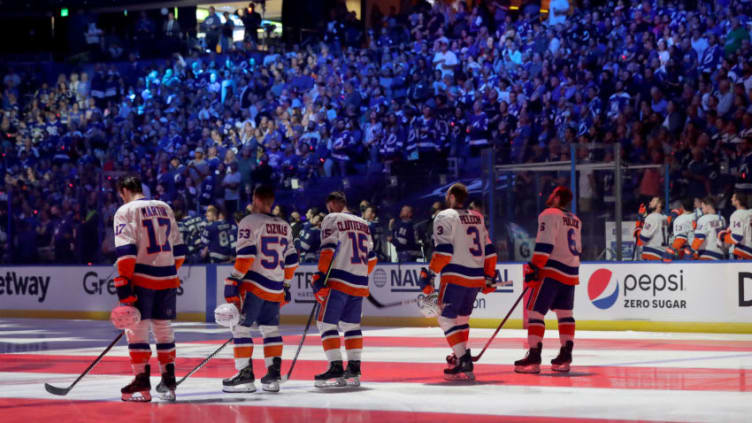TAMPA, FLORIDA - JUNE 15: Matt Martin #17, Casey Cizikas #53, Cal Clutterbuck #15, Adam Pelech #3 and Ryan Pulock #6 of the New York Islanders stand on the ice during the national anthem prior to Game Two of the Stanley Cup Semifinals against the Tampa Bay Lightning in the 2021 Stanley Cup Playoffs at Amalie Arena on June 15, 2021 in Tampa, Florida. (Photo by Mike Carlson/Getty Images)