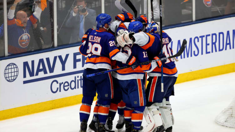 UNIONDALE, NEW YORK - JUNE 19: The New York Islanders celebrate their 3-2 win over the Tampa Bay Lightning after Game Four of the Stanley Cup Semifinals during the 2021 Stanley Cup Playoffs at Nassau Coliseum on June 19, 2021 in Uniondale, New York. (Photo by Rich Graessle/Getty Images)