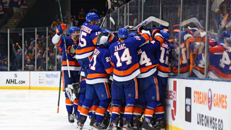 UNIONDALE, NEW YORK - JUNE 23: The New York Islanders celebrate after their 3-2 overtime victory against the Tampa Bay Lightning in Game Six of the Stanley Cup Semifinals during the 2021 Stanley Cup Playoffs at Nassau Coliseum on June 23, 2021 in Uniondale, New York. (Photo by Bruce Bennett/Getty Images)