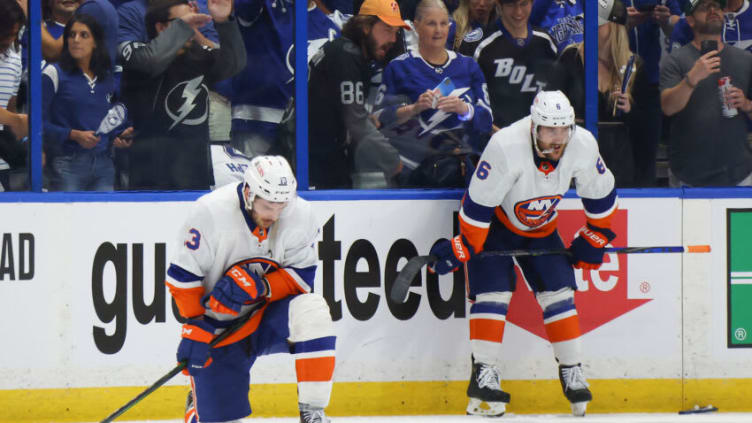 TAMPA, FLORIDA - JUNE 25: Mathew Barzal #13 and Ryan Pulock #6 of the New York Islanders react after their team's 1-0 loss against the Tampa Bay Lightning in Game Seven of the NHL Stanley Cup Semifinals during the 2021 NHL Stanley Cup Finals at Amalie Arena on June 25, 2021 in Tampa, Florida. (Photo by Bruce Bennett/Getty Images)