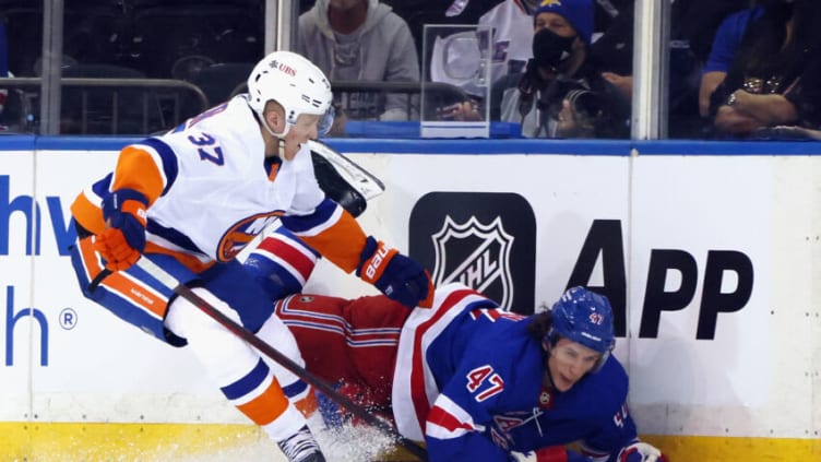 NEW YORK, NEW YORK - SEPTEMBER 26: Simon Holmstrom #37 of the New York Islanders trips up Morgan Barron #47 of the New York Rangers in a preseason game at Madison Square Garden on September 26, 2021 in New York City. The Islanders shutout the Rangers 4-0. (Photo by Bruce Bennett/Getty Images)