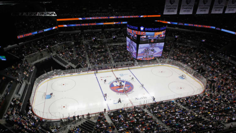 NEW YORK, NY - SEPTEMBER 21: The New York Islanders and the New Jersey Devils drop the opening puck during a preseason game at the Barclays Center on September 21, 2013 in Brooklyn borough of New York City.The game is the first professional hockey match to be held in the arena that is slated to be the new home for the Islanders at the start of the 2015-2016 season. The Devils defeated the islanders 3-0. (Photo by Bruce Bennett/Getty Images)