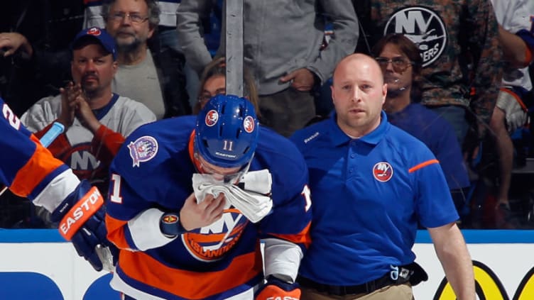 UNIONDALE, NY - APRIL 21: Lubomir Visnovsky #11 of the New York Islanders leaves the game after a hit by Tom Wilson #43 of the Washington Capitals during the second period in Game Four of the Eastern Conference Quarterfinals during the 2015 NHL Stanley Cup Playoffs at Nassau Veterans Memorial Coliseum on April 21, 2015 in Uniondale, New York. (Photo by Bruce Bennett/Getty Images)