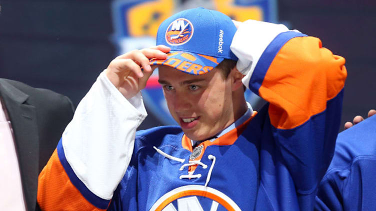 SUNRISE, FL - JUNE 26: Anthony Beauvillier puts on his hat after being selected 28th overall by the New York Islanders in the first round of the 2015 NHL Draft at BB&T Center on June 26, 2015 in Sunrise, Florida. (Photo by Bruce Bennett/Getty Images)