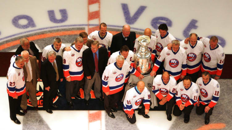 UNIONDALE, NY - MARCH 02: Former New York Islanders pose with the Stanley Cup before the game against the Florida Panthers at the Nassau Coliseum March 2, 2008 in Uniondale, New York. The Islanders are celebrating the 17 men that were part of all four Stanley Cup winning teams from 1980-1983. (Photo by Jim McIsaac/Getty Images)