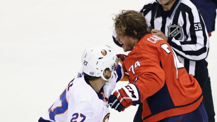 TORONTO, ONTARIO – AUGUST 12: Anders Lee #27 of the New York Islanders and John Carlson #74 of the Washington Capitals tangle during the first period in Game One of the Eastern Conference First Round during the 2020 NHL Stanley Cup Playoffs at Scotiabank Arena on August 12, 2020 in Toronto, Ontario, Canada. (Photo by Elsa/Getty Images)