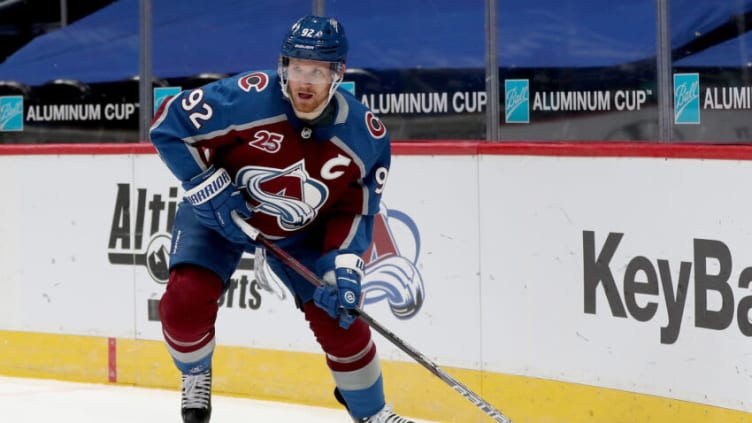 DENVER, COLORADO - JANUARY 26: Gabriel Landeskog #92 of the Colorado Avalanche brings the puck off the boards against the San Jose Sharks in the second period at Ball Arena on January 26, 2021 in Denver, Colorado. (Photo by Matthew Stockman/Getty Images)