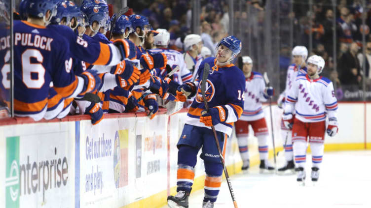 NEW YORK, NY - FEBRUARY 15: Thomas Hickey #14 of the New York Islanders celebrates with teammates after scoring a goal against the New York Rangers during their game at Barclays Center on February 15, 2018 in the Brooklyn borough of New York City. (Photo by Abbie Parr/Getty Images)