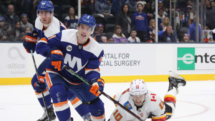 UNIONDALE, NEW YORK - FEBRUARY 26: Derek Ryan #10 of the Calgary Flames skates against Thomas Hickey #4 of the New York Islanders at NYCB Live's Nassau Coliseum on February 26, 2019 in Uniondale, New York. The Flames defeated the Islanders 3-1. (Photo by Bruce Bennett/Getty Images)