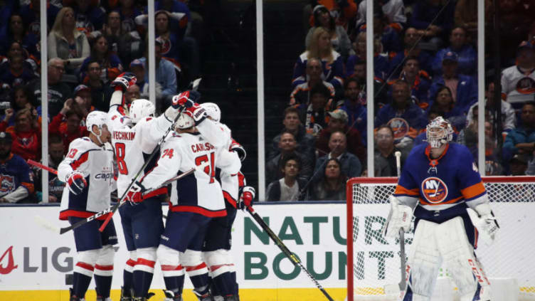 UNIONDALE, NEW YORK - OCTOBER 04: The Washington Capitals celebrate a power-play goal by T.J. Oshie #77 against Semyon Varlamov #40 of the New York Islanders at 17:43 of the second period at NYCB Live's Nassau Coliseum on October 04, 2019 in Uniondale, New York. (Photo by Bruce Bennett/Getty Images)