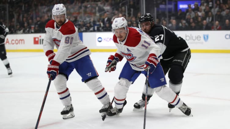 LOS ANGELES, CALIFORNIA - MARCH 05: Alec Martinez #27 of the Los Angeles Kings battles Tomas Tatar #90 and Brendan Gallagher #11 of the Montreal Canadiens for a loose puck during the first period of a game at Staples Center on March 05, 2019 in Los Angeles, California. (Photo by Sean M. Haffey/Getty Images)