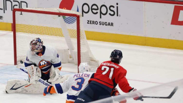 Jan 28, 2021; Washington, District of Columbia, USA; Washington Capitals right wing Garnet Hathaway (21) scores a goal on New York Islanders goaltender Semyon Varlamov (40) in the second period at Capital One Arena. Mandatory Credit: Geoff Burke-USA TODAY Sports