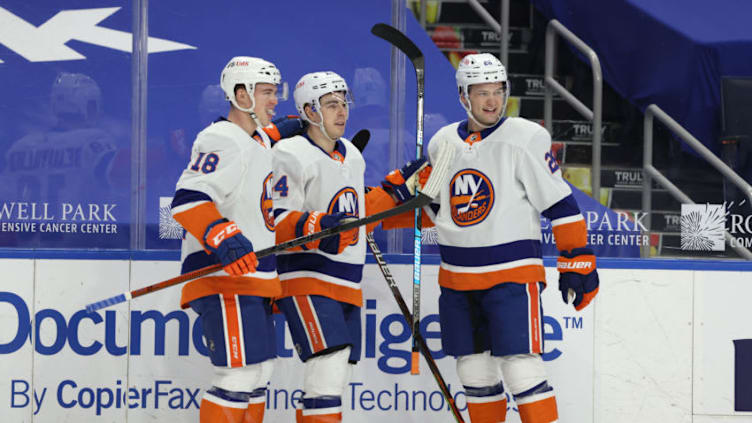 Feb 16, 2021; Buffalo, New York, USA; New York Islanders center Jean-Gabriel Pageau (44) celebrates with teammates after scoring a goal against the Buffalo Sabres during the first period at KeyBank Center. Mandatory Credit: Timothy T. Ludwig-USA TODAY Sports