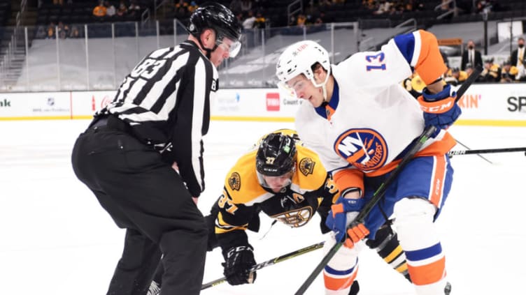 Mar 25, 2021; Boston, Massachusetts, USA; Boston Bruins center Patrice Bergeron (37) and New York Islanders center Mathew Barzal (13) face-off during the first period at TD Garden. Mandatory Credit: Bob DeChiara-USA TODAY Sports