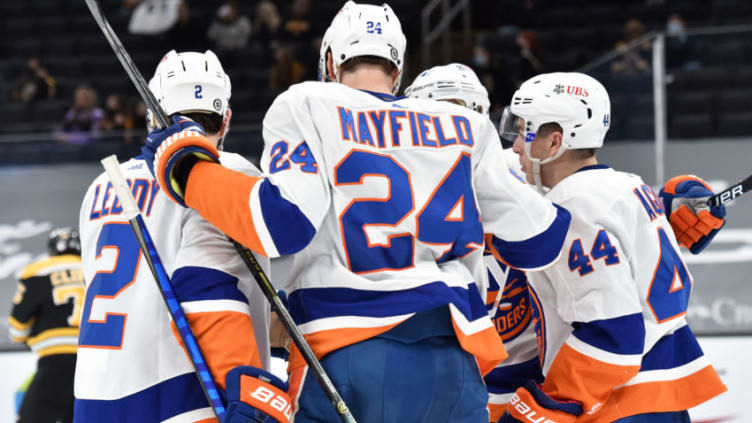 Mar 25, 2021; Boston, Massachusetts, USA; New York Islanders defenseman Nick Leddy (2) defenseman Scott Mayfield (24) celebrate a goal by center Jean-Gabriel Pageau (44) during the second period against the Boston Bruins at TD Garden. Mandatory Credit: Bob DeChiara-USA TODAY Sports