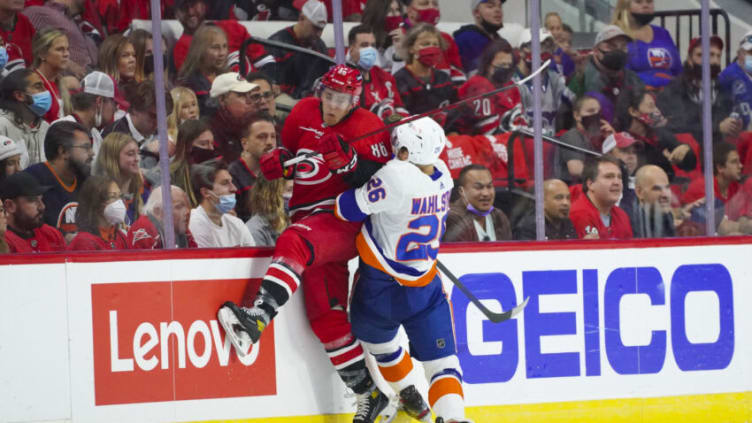 Oct 14, 2021; Raleigh, North Carolina, USA; aNew York Islanders right wing Oliver Wahlstrom (26) checks Carolina Hurricanes left wing Teuvo Teravainen (86) during the first period t PNC Arena. Mandatory Credit: James Guillory-USA TODAY Sports