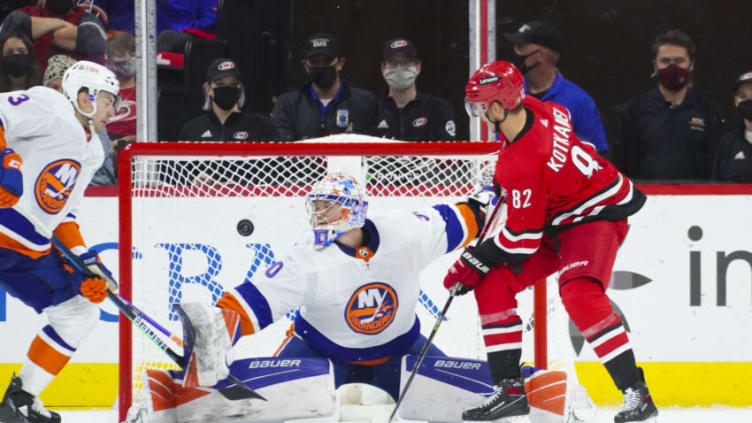 Oct 14, 2021; Raleigh, North Carolina, USA; New York Islanders goaltender Ilya Sorokin (30) stops the scoring attempt by Carolina Hurricanes center Jesperi Kotkaniemi (82) during the second period at PNC Arena. Mandatory Credit: James Guillory-USA TODAY Sports