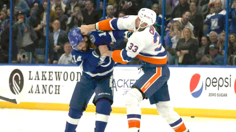 Nov 15, 2021; Tampa, Florida, USA; Tampa Bay Lightning left wing Pat Maroon (14) and New York Islanders defenseman Zdeno Chara (33) fight during the first period at Amalie Arena. Mandatory Credit: Kim Klement-USA TODAY Sports