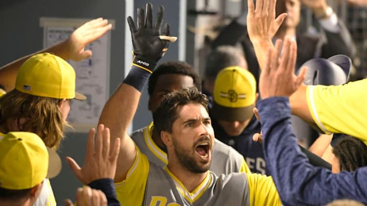 LOS ANGELES, CA - AUGUST 25: Austin Hedges #18 of the San Diego Padres is congratulated for his game tying run against the Los Angeles Dodgers in the nineth inning at Dodger Stadium on August 25, 2018 in Los Angeles, California. All players across MLB will wear nicknames on their backs as well as colorful, non-traditional uniforms featuring alternate designs inspired by youth-league uniforms during Players Weekend. (Photo by John McCoy/Getty Images)