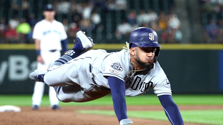 SEATTLE, WASHINGTON - AUGUST 06: Fernando Tatis Jr. #23 of the San Diego Padres dives into third to steal second and third base off a wild pitch by the Seattle Mariners in the ninth inning during their game at T-Mobile Park on August 06, 2019 in Seattle, Washington. (Photo by Abbie Parr/Getty Images)