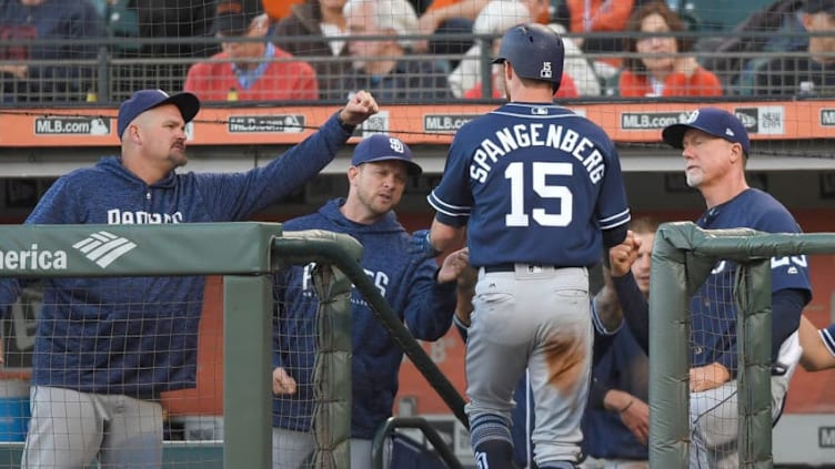 SAN FRANCISCO, CA - JUNE 22: Cory Spangenberg #15 of the San Diego Padres is congratulated by (L-R) David Wells, manager Andy Green #14 and coach Mark McGwire #25 after Spangenberg scored against the San Francisco Giants in the top of the second inning at AT&T Park on June 22, 2018 in San Francisco, California. (Photo by Thearon W. Henderson/Getty Images)