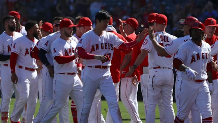 ANAHEIM, CA - SEPTEMBER 30: Shohei Ohtani #17 of the Los Angeles Angels of Anaheim and his teammates celebrate after Taylor Ward #3 (not in photo) hit a walk-off home run during the ninth inning of the the MLB game against the Oakland Athletics at Angel Stadium on September 30, 2018 in Anaheim, California. The Angels defeated the Athletics 5-4. (Photo by Victor Decolongon/Getty Images)